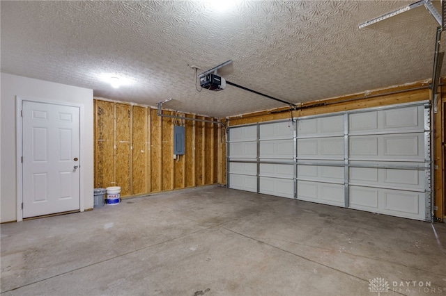 garage featuring electric panel and a garage door opener