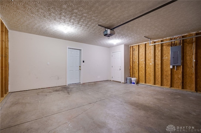 garage with electric panel and a garage door opener