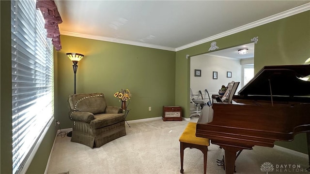 living area with baseboards, ornamental molding, and light colored carpet