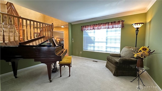 living area featuring carpet flooring, visible vents, baseboards, stairs, and crown molding