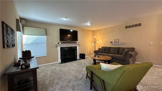 carpeted living area featuring a fireplace, visible vents, and baseboards