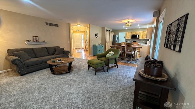 living area with baseboards and visible vents