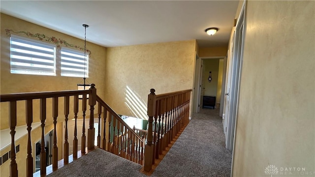 hall with carpet and an upstairs landing