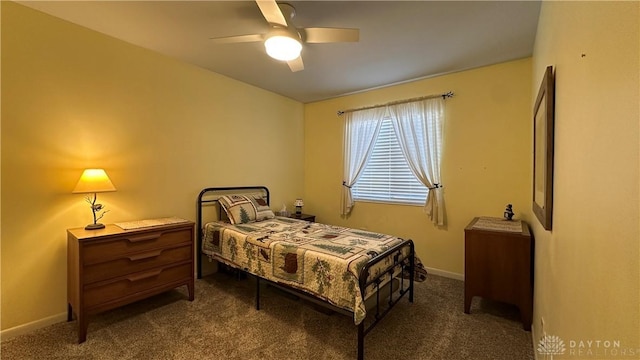 carpeted bedroom with a ceiling fan and baseboards