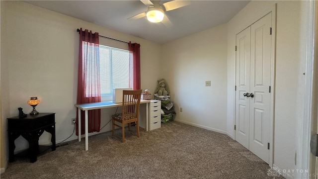 carpeted office with ceiling fan and baseboards