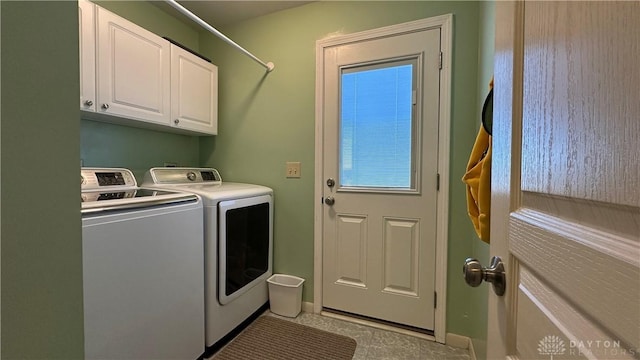 laundry room featuring cabinet space, baseboards, and separate washer and dryer