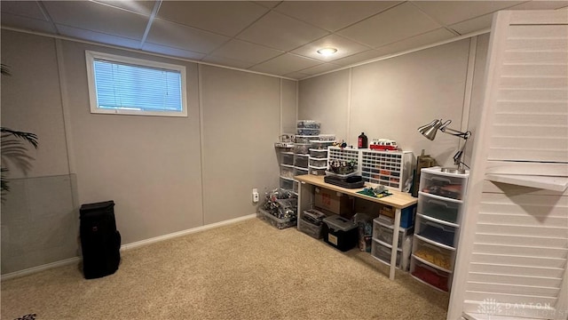 carpeted office featuring a drop ceiling and baseboards