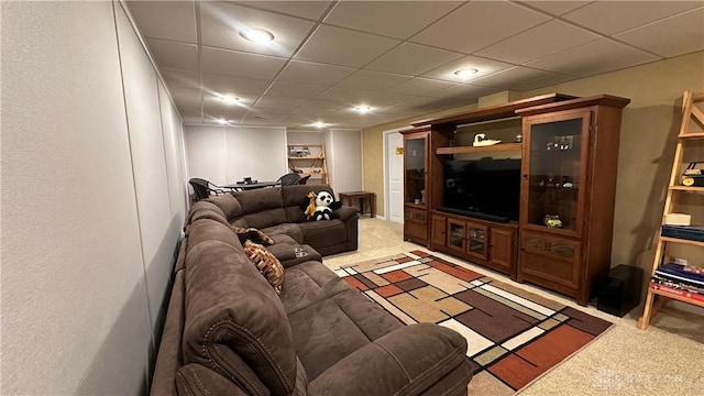 living area with light carpet and a drop ceiling