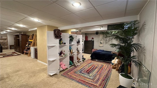 finished basement with carpet floors and a drop ceiling