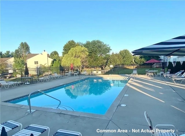 pool featuring a patio area and fence