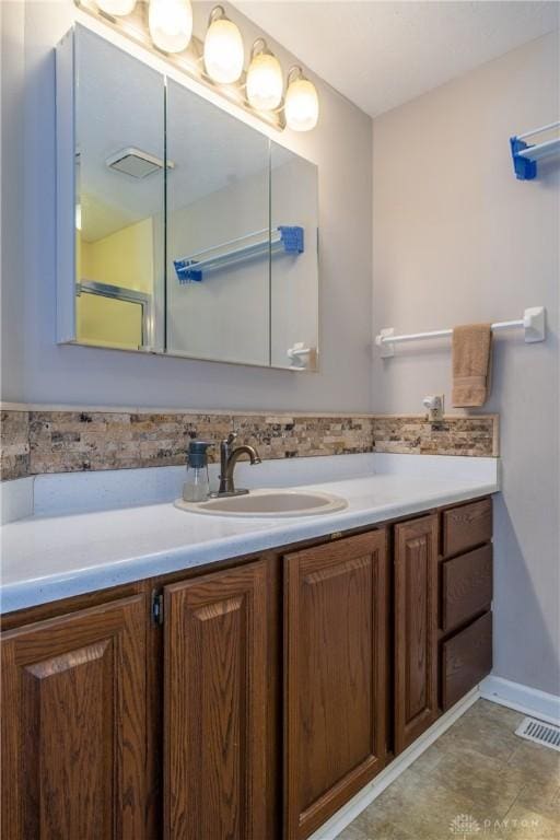 bathroom featuring backsplash, visible vents, and vanity