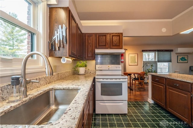 kitchen with under cabinet range hood, a sink, a wall mounted AC, backsplash, and white range with electric stovetop