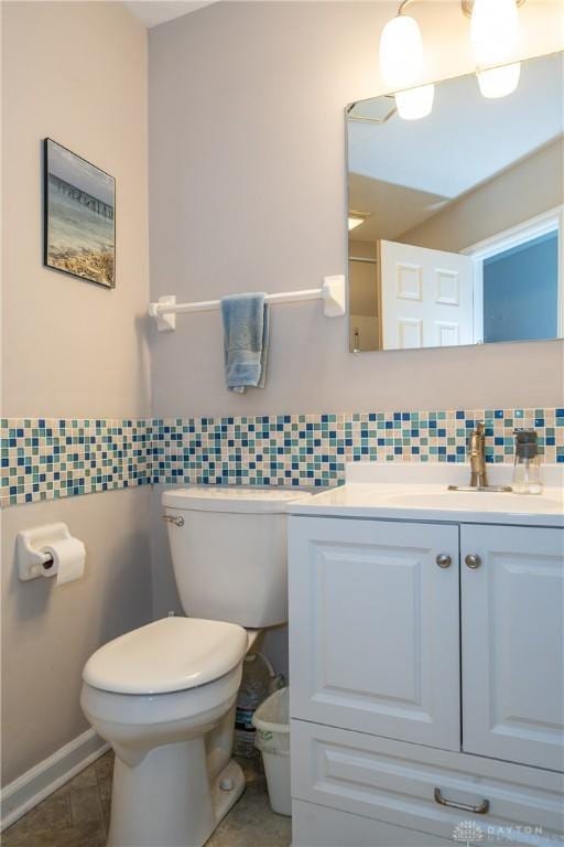 bathroom with tile walls, vanity, and toilet