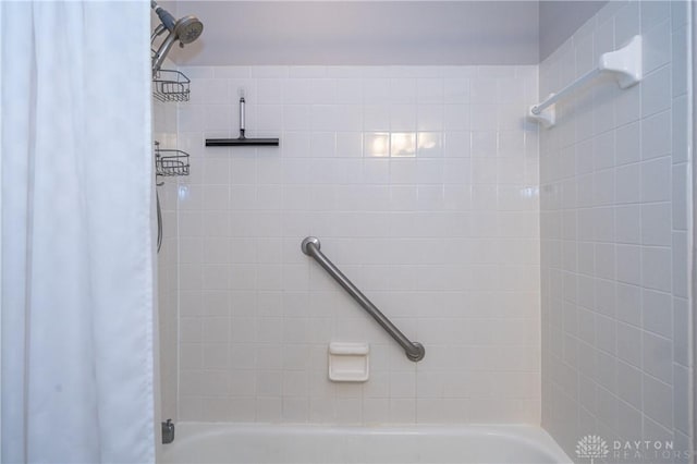 bathroom with shower / bathtub combination with curtain