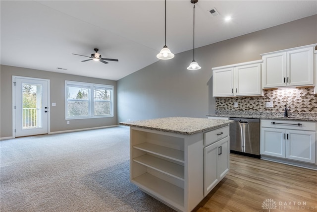 kitchen with a center island, open shelves, visible vents, backsplash, and stainless steel dishwasher