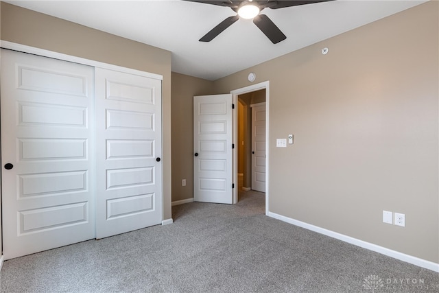 unfurnished bedroom featuring ceiling fan, carpet floors, a closet, and baseboards