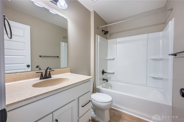 full bath with toilet, shower / washtub combination, wood finished floors, and vanity