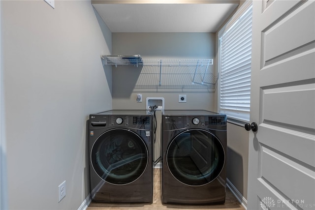 laundry area featuring laundry area, baseboards, and separate washer and dryer