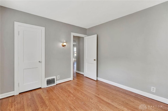 543 W Market St, Germantown, OH 45327 - unfurnished bedroom with baseboards and light wood-type flooring