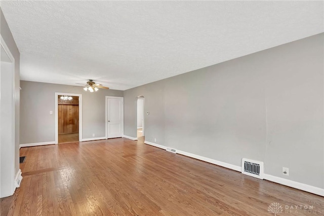 543 W Market St, Germantown, OH 45327 - unfurnished room with a ceiling fan, wood finished floors, arched walkways, baseboards, and a textured ceiling