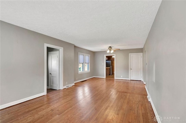 543 W Market St, Germantown, OH 45327 - spare room with light wood-style floors, baseboards, ceiling fan, and a textured ceiling