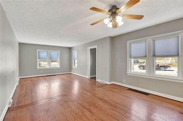 543 W Market St, Germantown, OH 45327 - empty room with a textured ceiling, wood finished floors, baseboards, and a ceiling fan