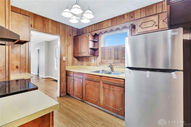 543 W Market St, Germantown, OH 45327 - kitchen with freestanding refrigerator, a sink, a chandelier, light countertops, and light wood-type flooring