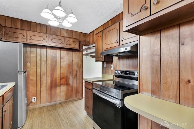 543 W Market St, Germantown, OH 45327 - kitchen with stainless steel appliances, under cabinet range hood, light wood-style floors, light countertops, and a textured ceiling