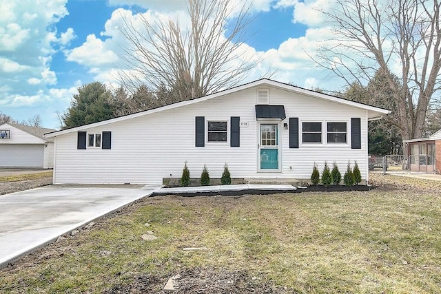 view of front of home with a front yard and fence