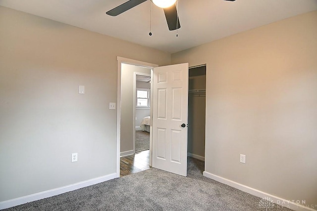 unfurnished bedroom featuring ceiling fan, carpet floors, a closet, and baseboards