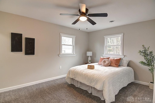 carpeted bedroom featuring ceiling fan, visible vents, and baseboards