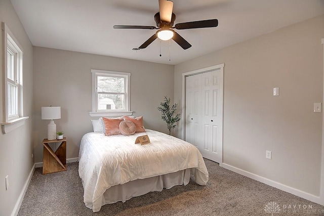 bedroom with ceiling fan, a closet, carpet, and baseboards