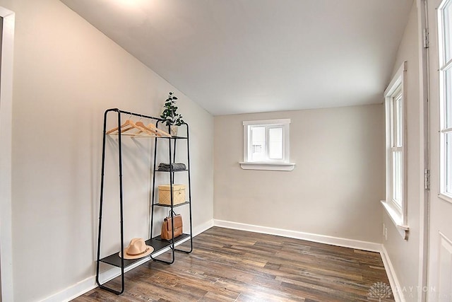 unfurnished room featuring dark wood-style floors and baseboards