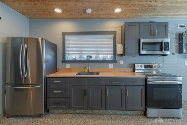 kitchen featuring stainless steel appliances, recessed lighting, light countertops, wood ceiling, and a sink