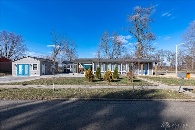 view of front of home with driveway and an attached carport