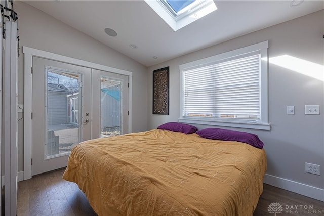 bedroom with wood finished floors, baseboards, access to outside, french doors, and lofted ceiling with skylight