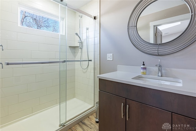 full bath featuring toilet, a shower stall, vanity, and wood finished floors