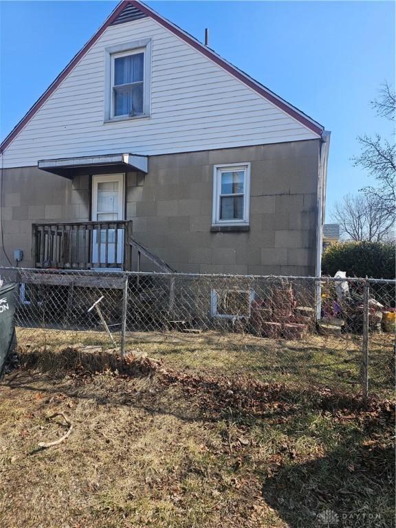 back of property featuring fence