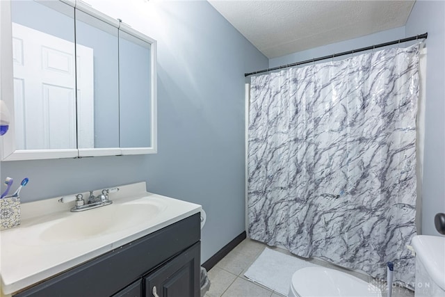 bathroom with a shower with curtain, tile patterned flooring, vanity, toilet, and a textured ceiling