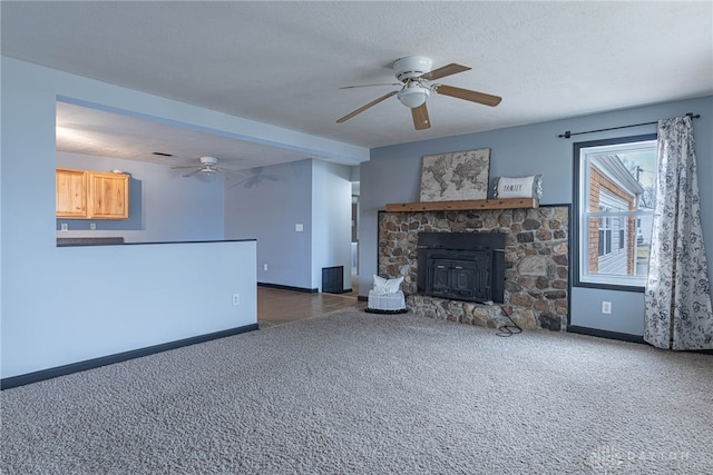 unfurnished living room with a ceiling fan, baseboards, and carpet floors