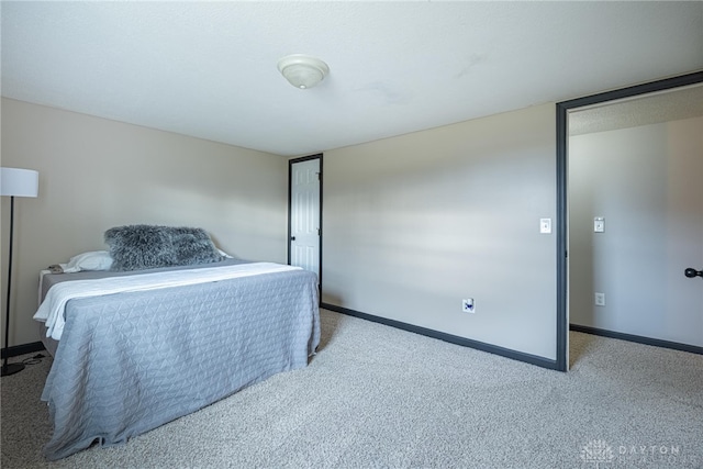 bedroom with carpet and baseboards