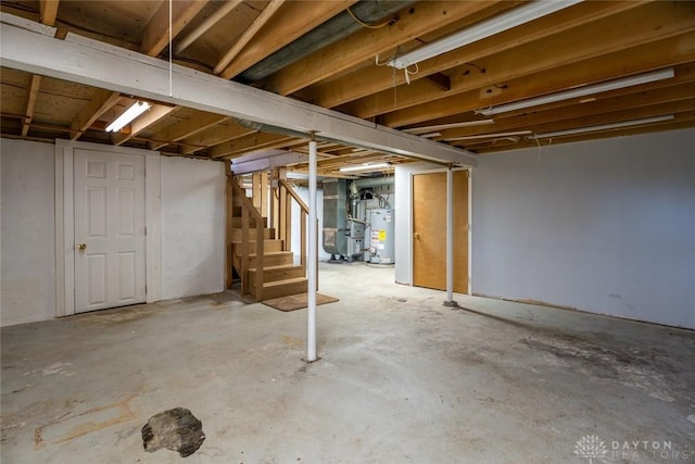 unfinished below grade area with water heater, stairway, and heating unit