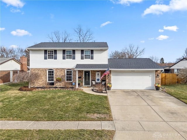 view of front of house featuring a garage, brick siding, and a front yard