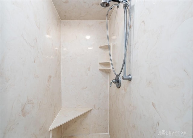 bathroom with a marble finish shower