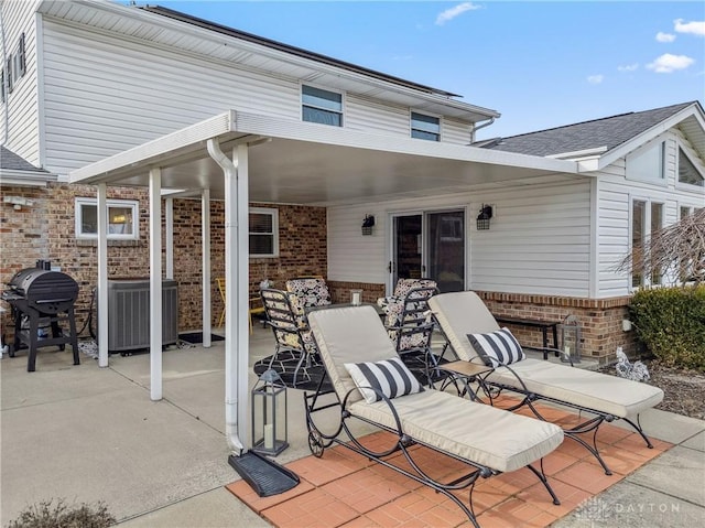 view of patio / terrace featuring cooling unit and a grill