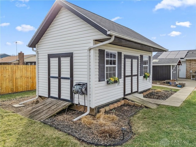 view of shed with fence