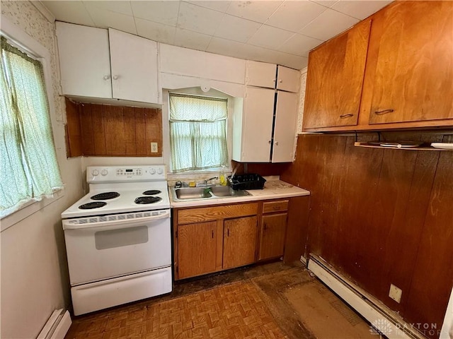 kitchen featuring white range with electric stovetop, baseboard heating, light countertops, a baseboard heating unit, and a sink