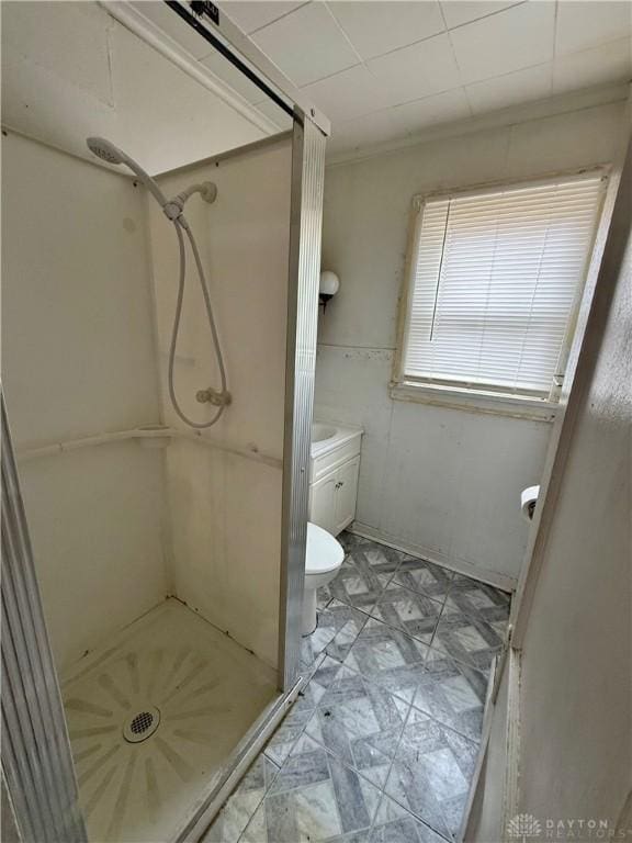 bathroom featuring a shower stall, toilet, and tile patterned floors