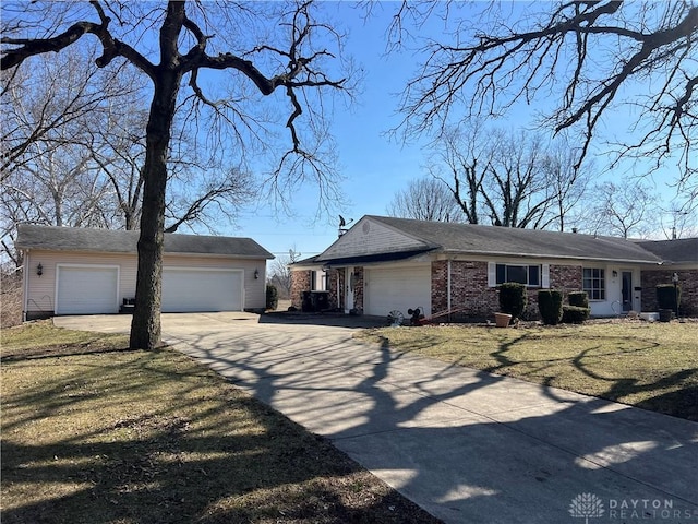 view of front of house with concrete driveway, brick siding, an attached garage, and a front yard