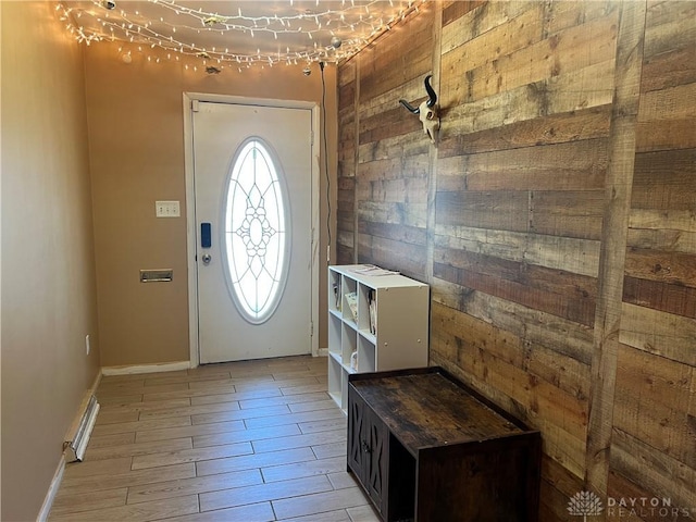 foyer featuring baseboards and light wood-style floors